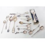 A small collection of continental and oriental white metal ornate spoons and English silver spoons -