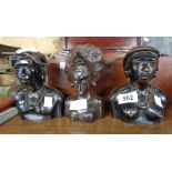 Three small carved wooden busts of women