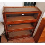 An 88cm early 20th Century stained mixed wood Lebus three section bookcase with base - cornice
