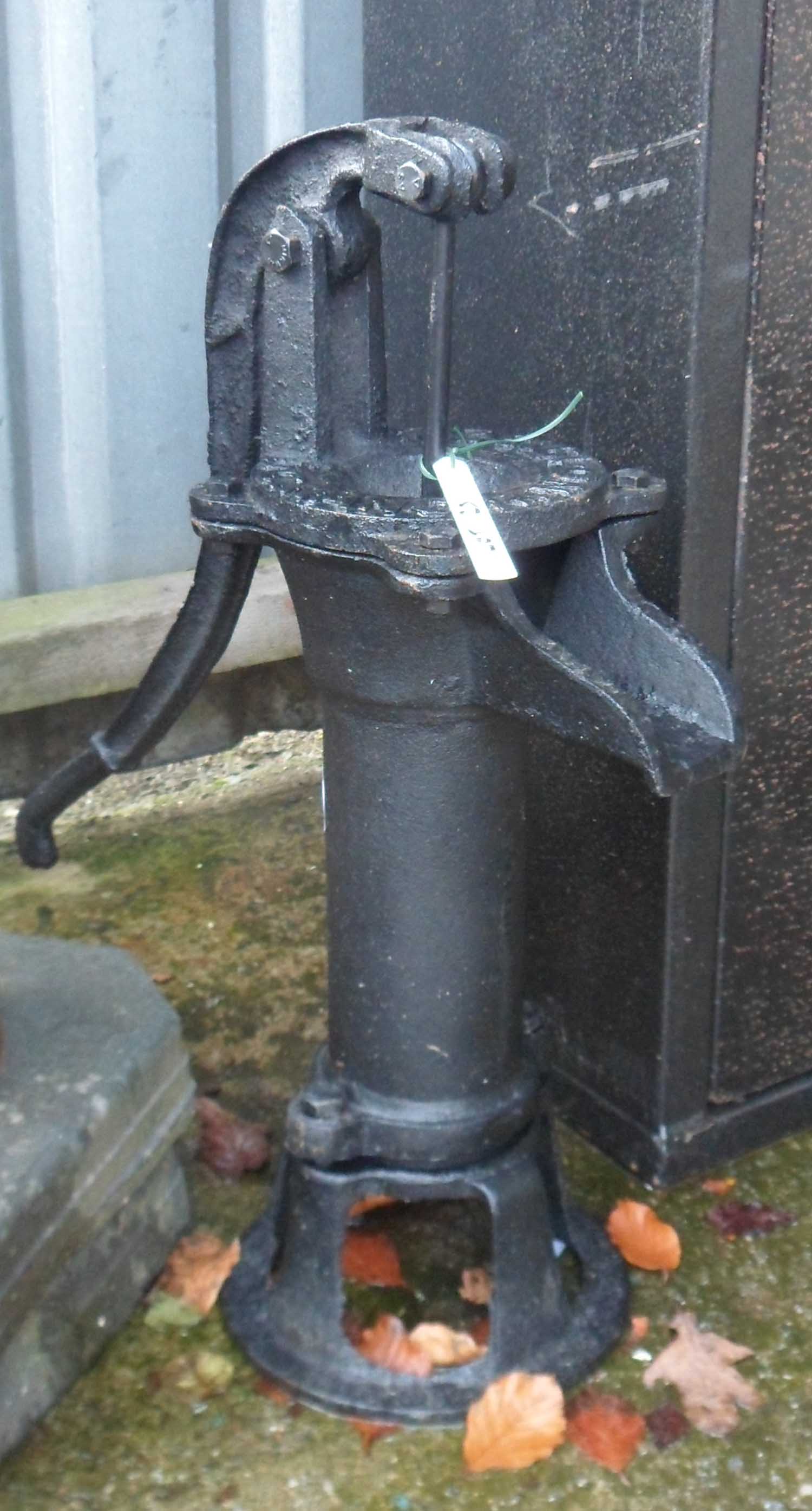A reproduction cast iron garden pump