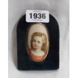 A velvet easel framed portrait miniature on curved panel, depicting a young girl