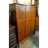 A 1.35m Vanson retro teak effect triple wardrobe with shelf and hanging space, set on a raised