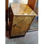 A 36cm 1930's figured walnut veneered bedside cabinet with ebonised base