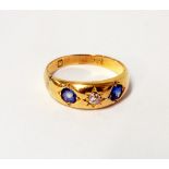 A hallmarked high carat gypsy set sapphire and diamond ring