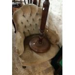 A late Victorian scallop top parlour armchair with button back upholstery, set on turned front