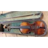 An antique Stradivarius copy violin with bow in wooden case
