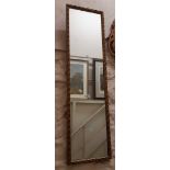 A vintage decorative gilt framed narrow oblong wall mirror