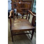 A 19th Century oak framed elbow chair with reeded rail back, panelled seat and open armrests, set on