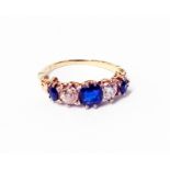 An antique high carat ring, set with two diamonds interspersed with three graduated sapphires -