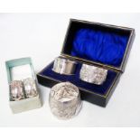 A fitted case containing a silver napkin ring with blank cartouche and another marked T80P - sold