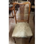 A pair of Edwardian mahogany and strung framed dining chairs with pierced splat backs and