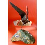 A bronze figurine of an Arctic Tern in flight mounted on a stone plinth, by Grace Critchley