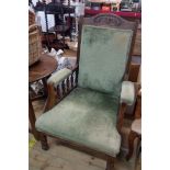 An Edwardian walnut part show frame drawing room armchair with green velour upholstery, set on
