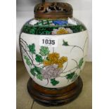A 19th Century Chinese famille verte partially unglazed ginger jar with carved wood lid and stand
