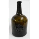 A late Georgian green glass wine bottle with applied seal for Thomas Hele, Folly 1792