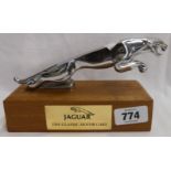 An original Jaguar car mascot mounted on wood base