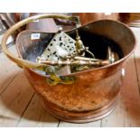 A coal helmet containing assorted brass and copper items