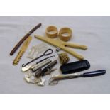 A bag of assorted collectables including glove stretchers, napkin rings, Japanese paper knife,
