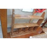 An 84cm waxed pine wall hanging shelf with arcaded sections to top and shaped sides