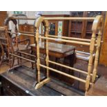 Two Victorian style double towel rails, comprising a dark stained beech, the other blonde wood