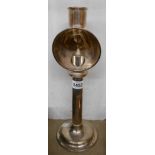A vintage silver plated student's candle desk lamp with loaded circular base