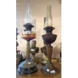 A brass Corinthian column table oil lamp with faceted glass reservoir - sold with a similar brass