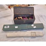 A metal box containing assorted dominoes and draught pieces - sold with a cased slide rule