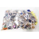 A bag containing a large quantity of assorted costume jewellery