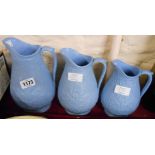 A set of three Victorian graduated moulded blue silicone ware jugs - largest cracked