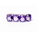 A white metal four stone amethyst brooch