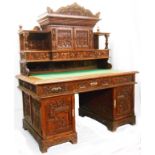 A 1.53m Chinese export polished carved hardwood twin pedestal desk, the ornate superstructure with