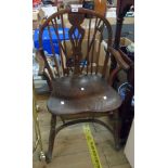 An antique hoop stick back elbow chair with moulded solid elm seat, set on turned supports and