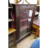 A 91cm early 20th Century walnut display cabinet with decorative carved relief cartouches and