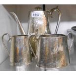 An antique silver plated three piece coffee set of tapered oval design with engraved foliate and