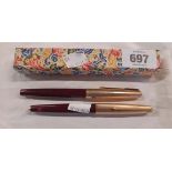 Two red Parker fountain pens with rolled gold lids - sold with a boxed pen
