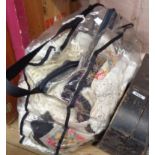 A bag of vintage linen and lace including children's dresses, runners, material, etc.