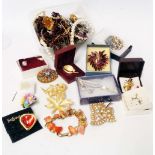 A bag containing a quantity of assorted boxed and loose costume jewellery