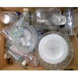 A box containing assorted glassware including vases, cake plates, bottles, etc.