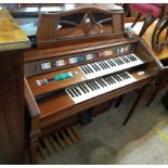 A vintage Wurlitzer Total Tone Custom twin bank electric organ in polished wood case with moulded