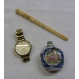 A Fossil watch, carved cheroot holder, and a Chinese porcelain snuff bottle