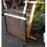 A large wrought iron and mesh fire guard - sold with a wooden pine bed end
