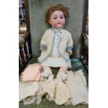 A large Armand Marseille AM 13 doll (severe haircut) - sold with a quantity of knitted clothes
