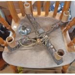 A mid 20th Century carved oak four branch ceiling light fitting with brass suspender and chains