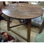 A 70cm diameter late Georgian oak cricket table, set on chamfered supports and stretchers - old