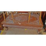 A 1.27m modern Chinese carved hardwood coffee table with profuse floral and foliate scroll