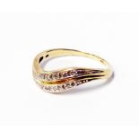 A marked 375 yellow metal ring with two rows of tiny diamonds in wave setting