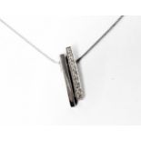 A marked 375 white metal and tiny diamond pendant, on 375 chain