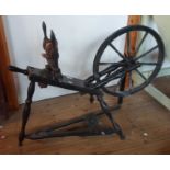 A 19th century ebonised wood spinning wheel