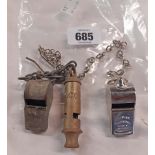 Three whistles and chains including LCC, Acme Thunderer, and another