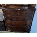 A 69cm reproduction mahogany and crossbanded bow front chest of two short and three long graduated